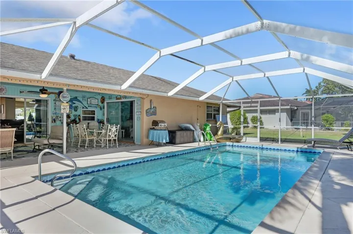 Swimming pool featuring a lanai, a patio, and a sunroom