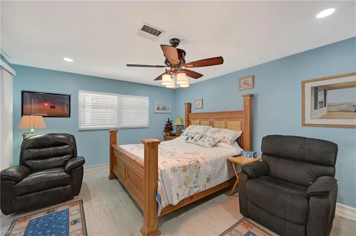 Bedroom featuring recessed lighting, a ceiling fan, and wood finished floors