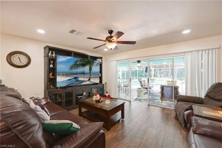 Living area with hardwood / wood-style floors, a ceiling fan, and recessed lighting