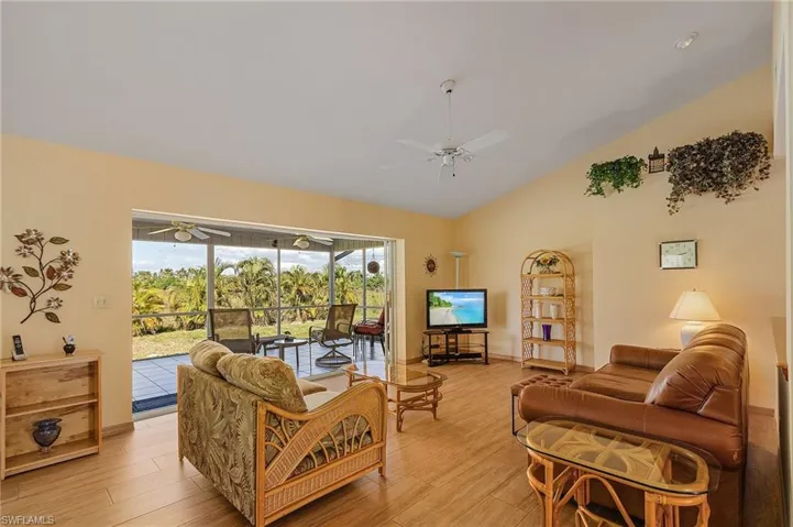 Spacious living room with pocket sliding glass doors out to the screened lanai.