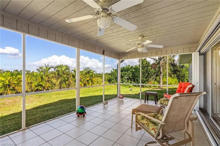 Screened lanai with tile floors overlooking the backyard.