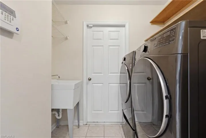 Laundry with door leading to garage
