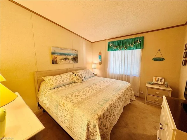 Bedroom featuring carpet flooring and crown molding