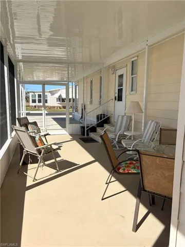View of patio featuring a sunroom