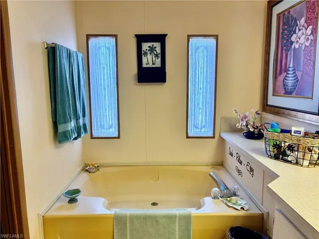 Bathroom featuring vanity and a garden tub