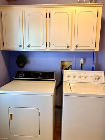 Laundry room featuring washer and dryer and cabinet space