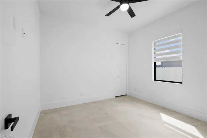 Unfurnished bedroom with ceiling fan and baseboards
