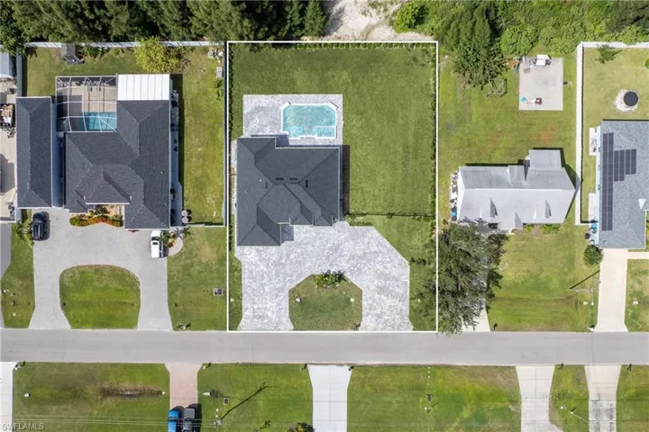 Aerial perspective of suburban area with property parcel outlined