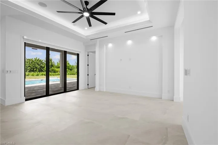 Spare room with recessed lighting, a ceiling fan, and a raised ceiling