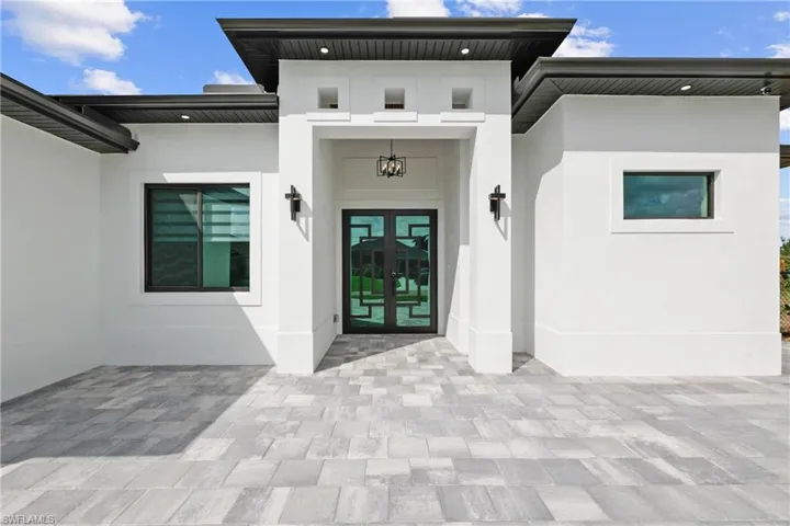 Entrance to property with stucco siding and french doors