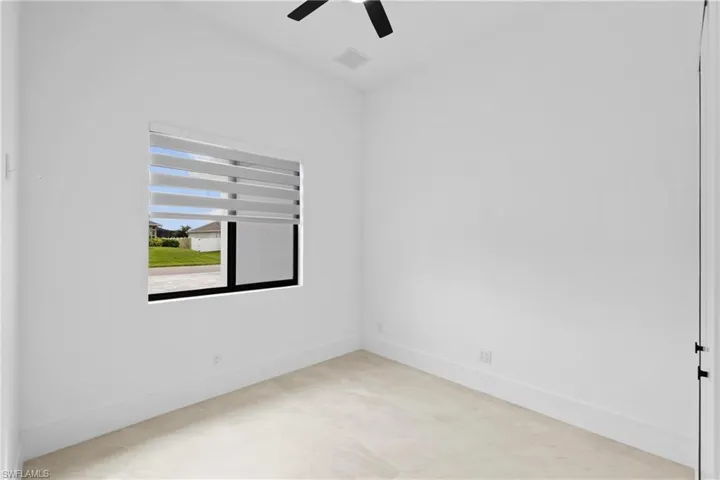 Unfurnished room featuring baseboards and a ceiling fan