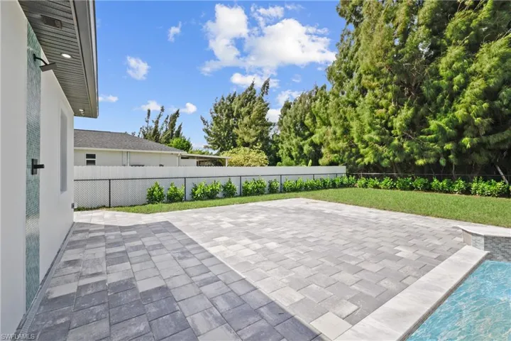 Fenced backyard with a patio area