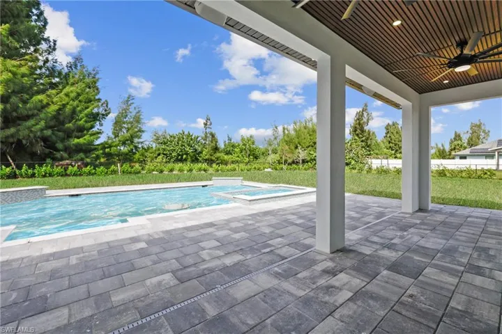 View of swimming pool featuring a patio and a pool with connected hot tub