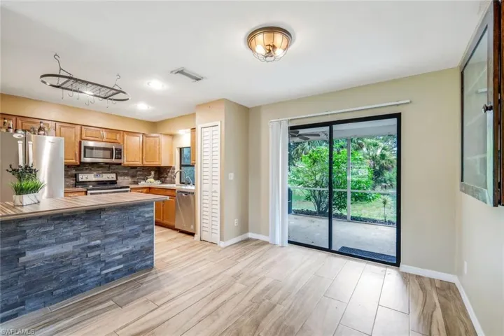 Kitchen featuring stainless steel appliances, backsplash, and sink