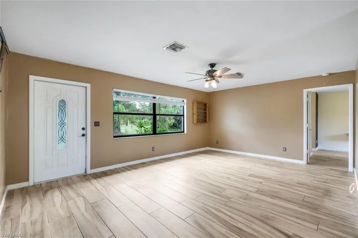 Entryway with light hardwood / wood-style floors and ceiling fan