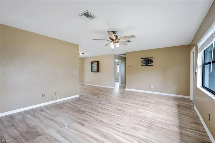 Spare room featuring ceiling fan and light hardwood / wood-style flooring