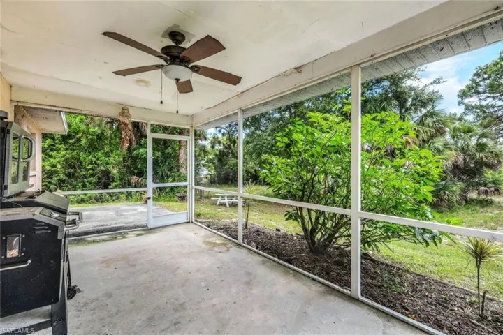 Unfurnished sunroom with ceiling fan