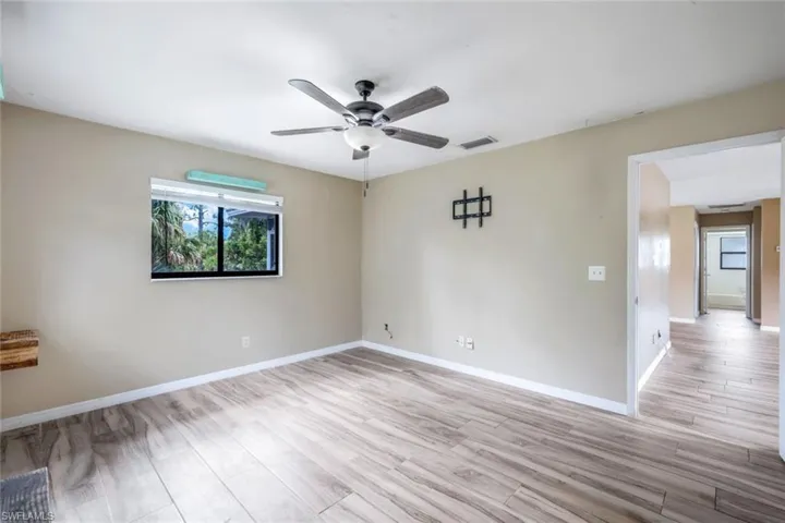 Empty room featuring light hardwood / wood-style floors and ceiling fan