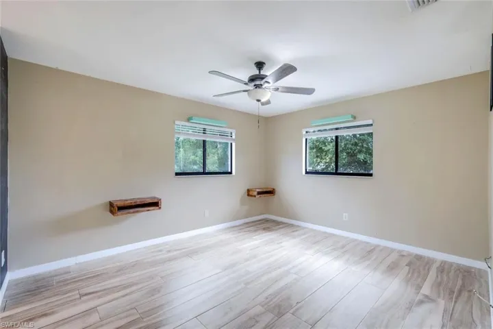 Spare room with ceiling fan and light hardwood / wood-style floors