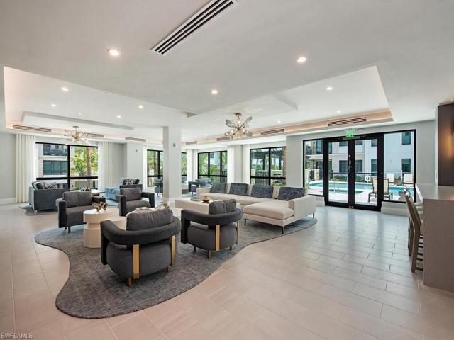Quattro at Naples Square Community area offers a billards table, game area, large-screen TV's, and chefs kitchen for entertaining and direct access to pool.