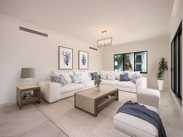 Great Room/Living Room/Kitchen/Dining Room feature beautiful tile floors throughout the condo. Luxury finishes and high-end appliances, quartz countertops, custom cabinetry. Open, airy, and bright, you feel right at home for a Naples Paradise get-away or to entertain with ease.