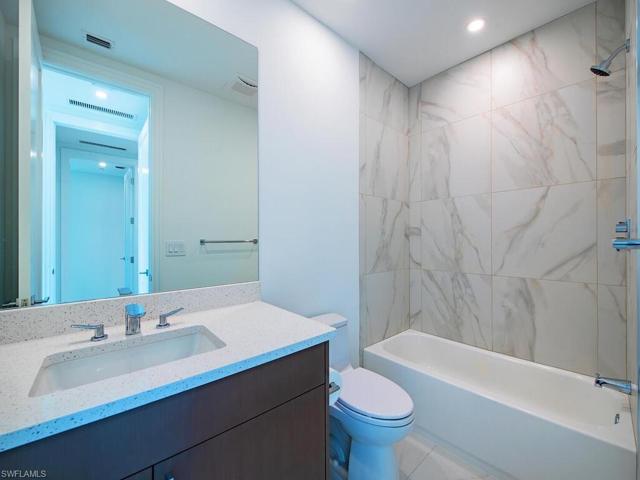 Ensuite Bath Room for 2nd Bedroom boasts a large tub with quartz countertop vanity.