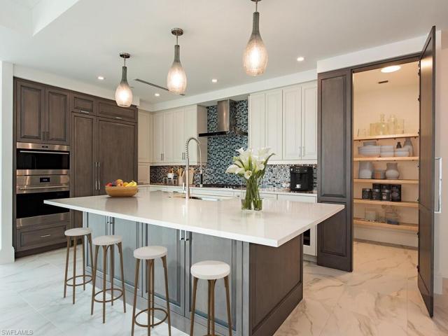 Expansive quartz countertops, storage galore, and large walk-in pantry.