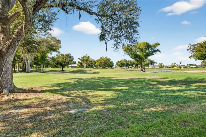 View of home's community with a lawn and view of golf course