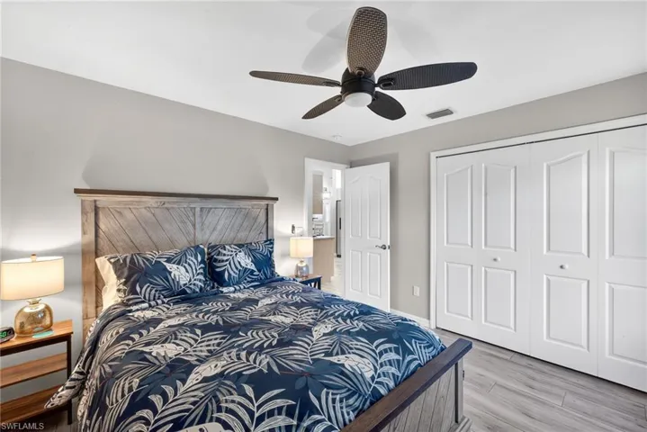 Bedroom with a closet, light wood-style flooring, and ceiling fan