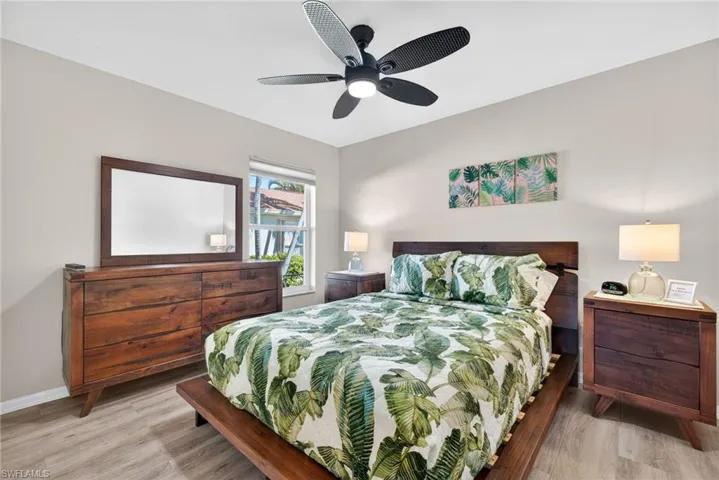 Bedroom with light wood finished floors and a ceiling fan