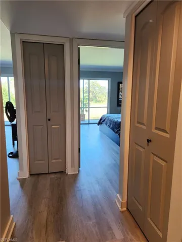 Hallway with dark wood-style flooring