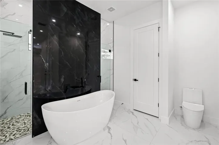 Bathroom with shower with separate bathtub and toilet