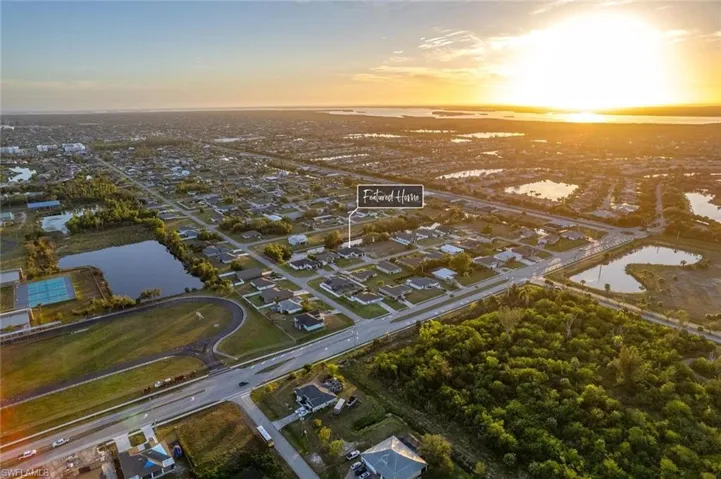 Aerial view at dusk featuring a water view