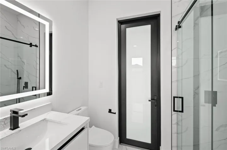 Bathroom with vanity, toilet, and walk in shower
