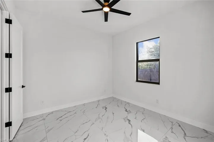 Unfurnished room featuring ceiling fan