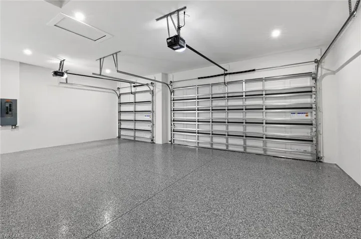 Garage with electric panel and a garage door opener