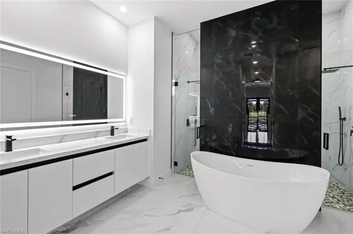 Bathroom featuring plus walk in shower and vanity