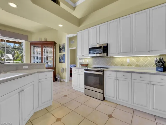 Kitchen featuring white cabinetry, stainless steel appliances