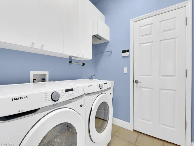 Laundry with cabinets and laundry sink