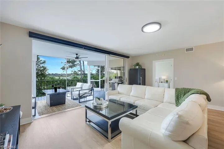 Living room featuring wood finished floors and a ceiling fan