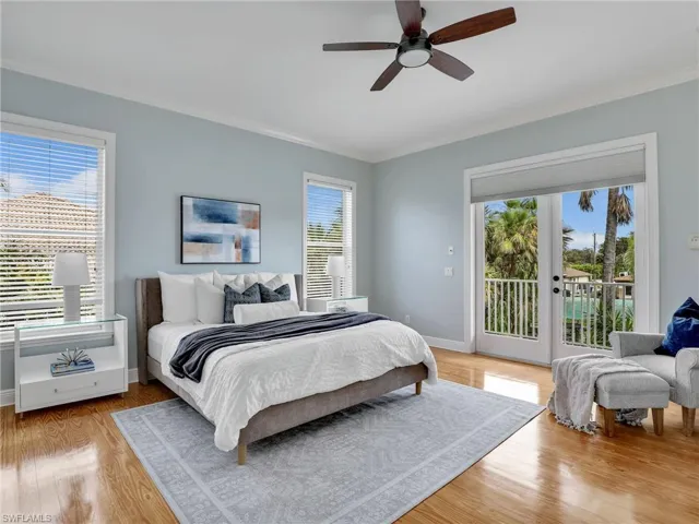 Bedroom with crown molding, access to exterior, and light wood-type flooring