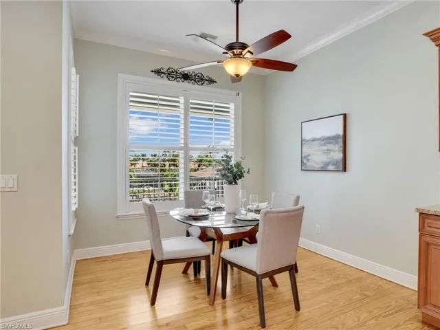 Dining space with crown molding, ceiling fan, and light hardwood / wood-style floors