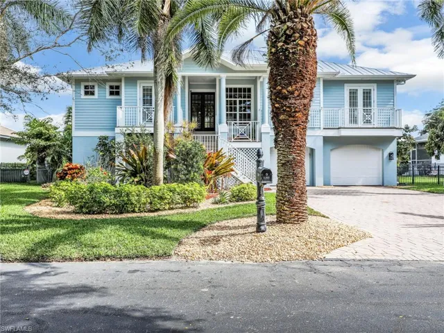 View of front of house with french doors and a garage