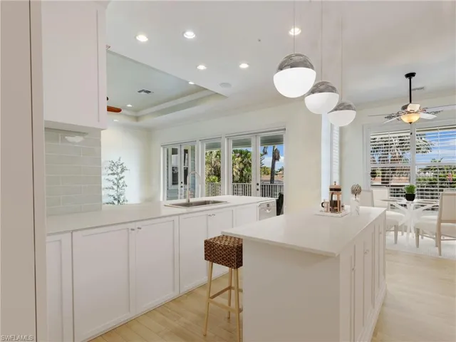 If your looking update to a coastal kitchen check out the rendering of the  Reality Staged kitchen with a center island with white countertops, white cabinetry