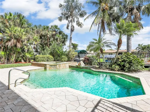 View of pool with an in ground hot tub and a patio