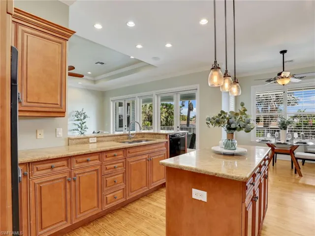 Kitchen featuring sink, a center island, dishwasher, and ceiling fan