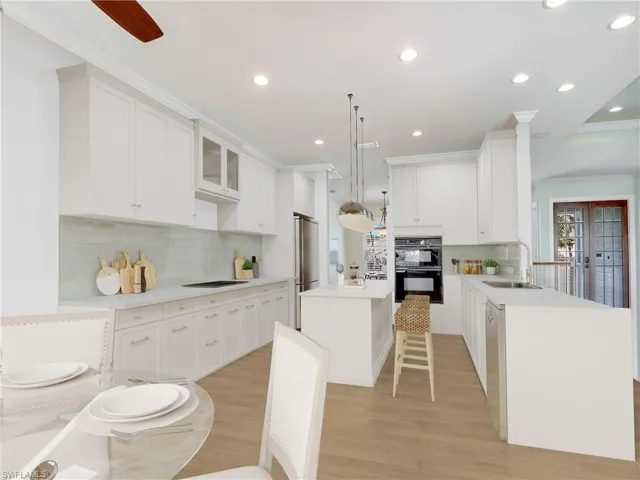 If your looking to update to a coastal kitchen ...check out the rendering of The Reality Staged Kitchen featuring a center island, light countertops, white cabinets, black appliances