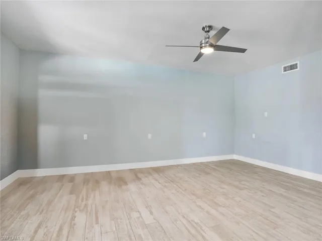 Spare room featuring ceiling fan and light wood-type flooring