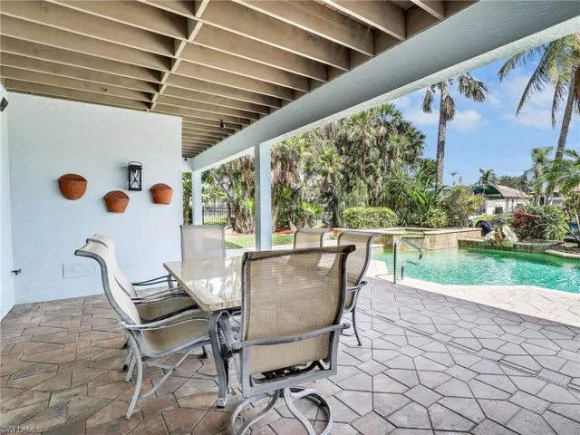 View of patio / terrace featuring a swimming pool with hot tub