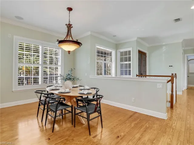 Dining room featuring ornamental molding and light wood-type flooring